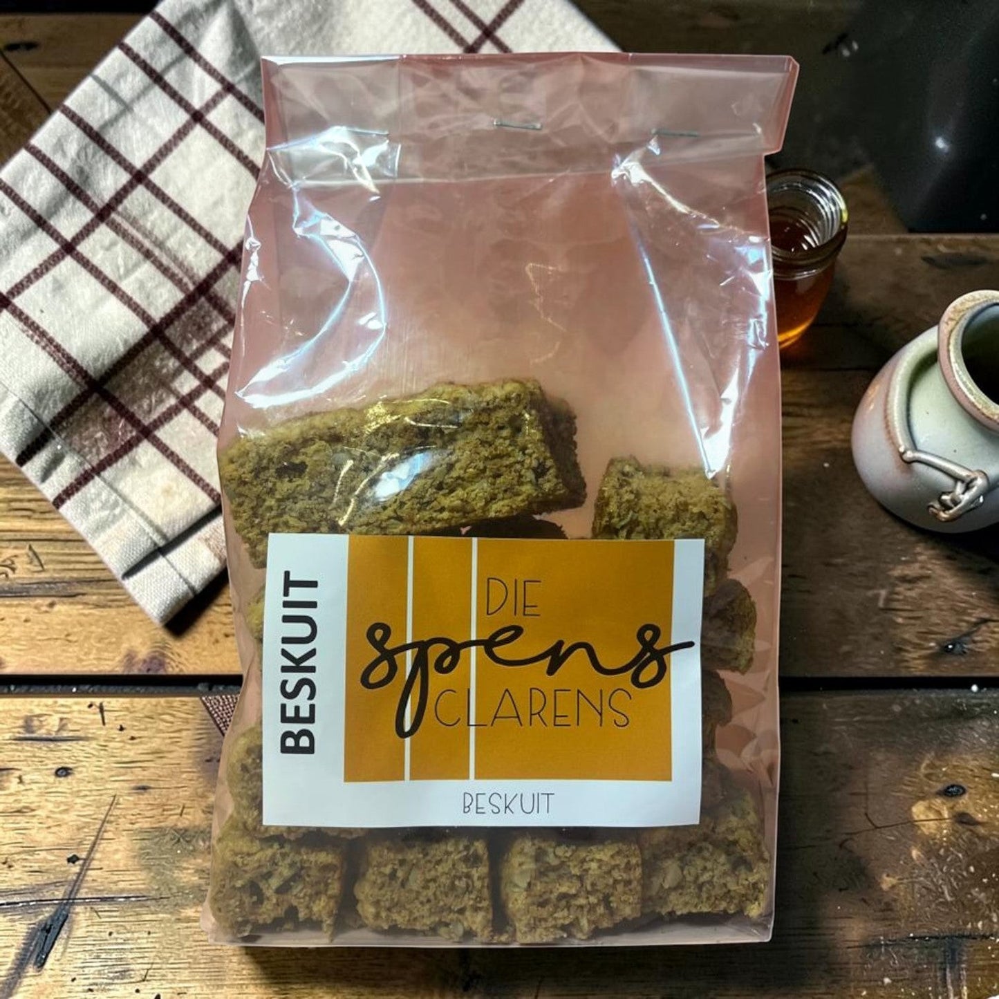Die Spens Clarens All Bran Beskuit biscuits in a clear plastic bag, showing their textured, golden-brown appearance.