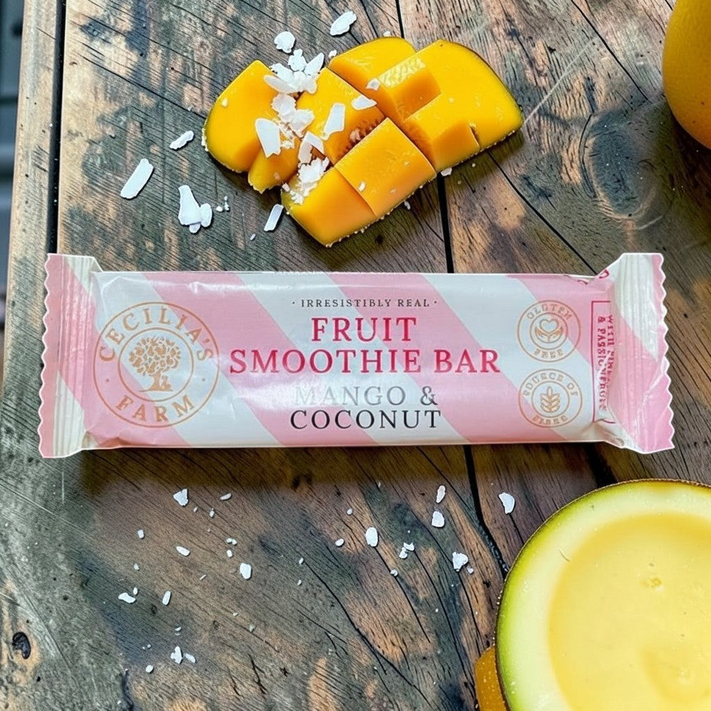 Die Spens Clarens Cecilias Farm Mango & Coconut Fruit Smoothie Bar packaging with fresh mango slices and coconut flakes.