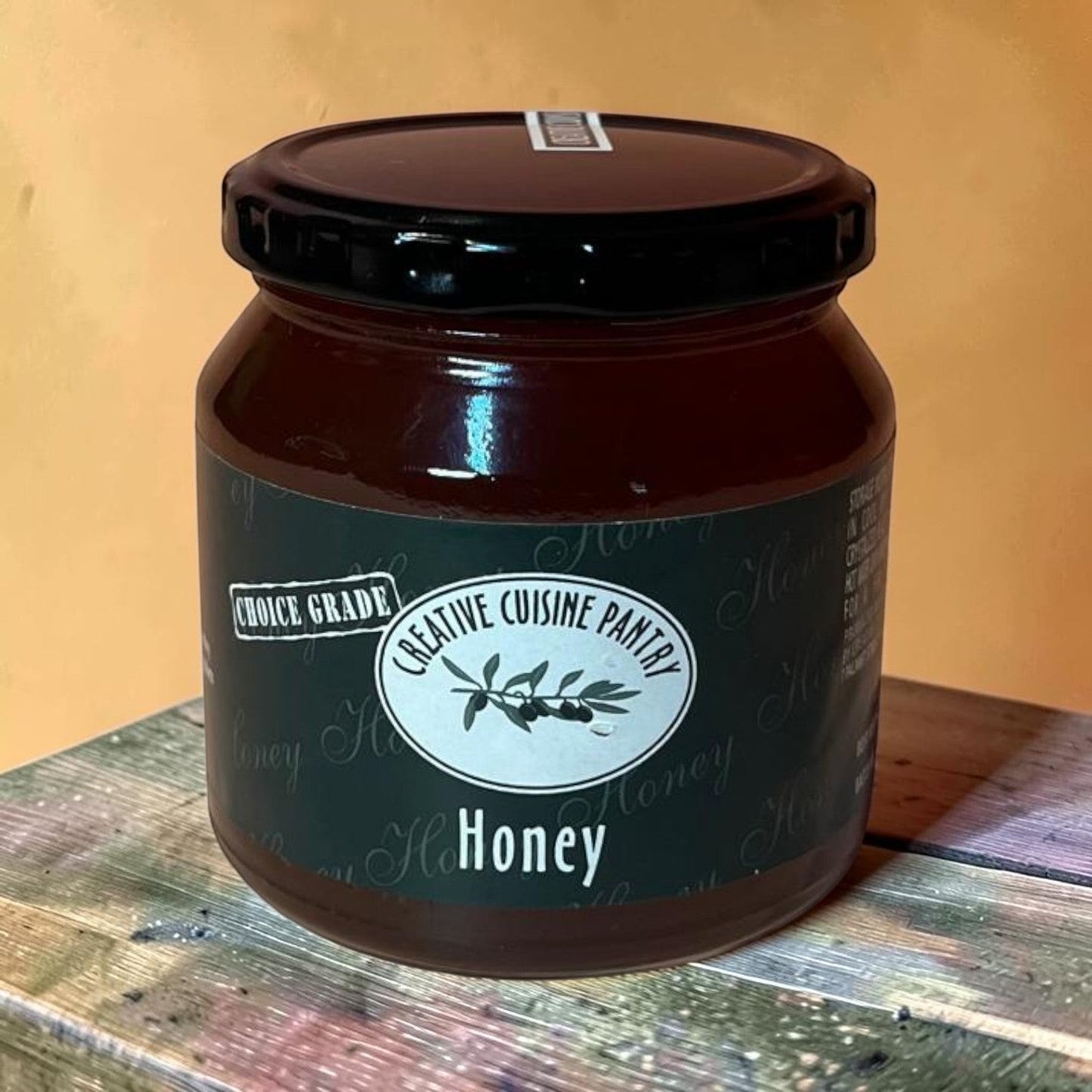 Die Spens Clarens Choice Grade Creative Cuisine Pantry amber honey in a glass jar with a black lid.