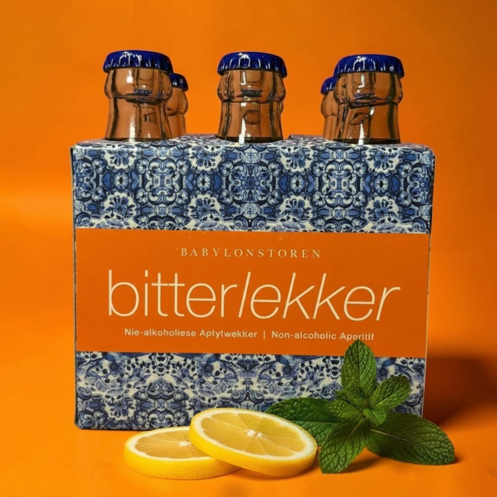 Die Spens Clarens Babylonstoren Bitterlekker non-alcoholic aperitif in decorative bottles with lemon slices and mint.
