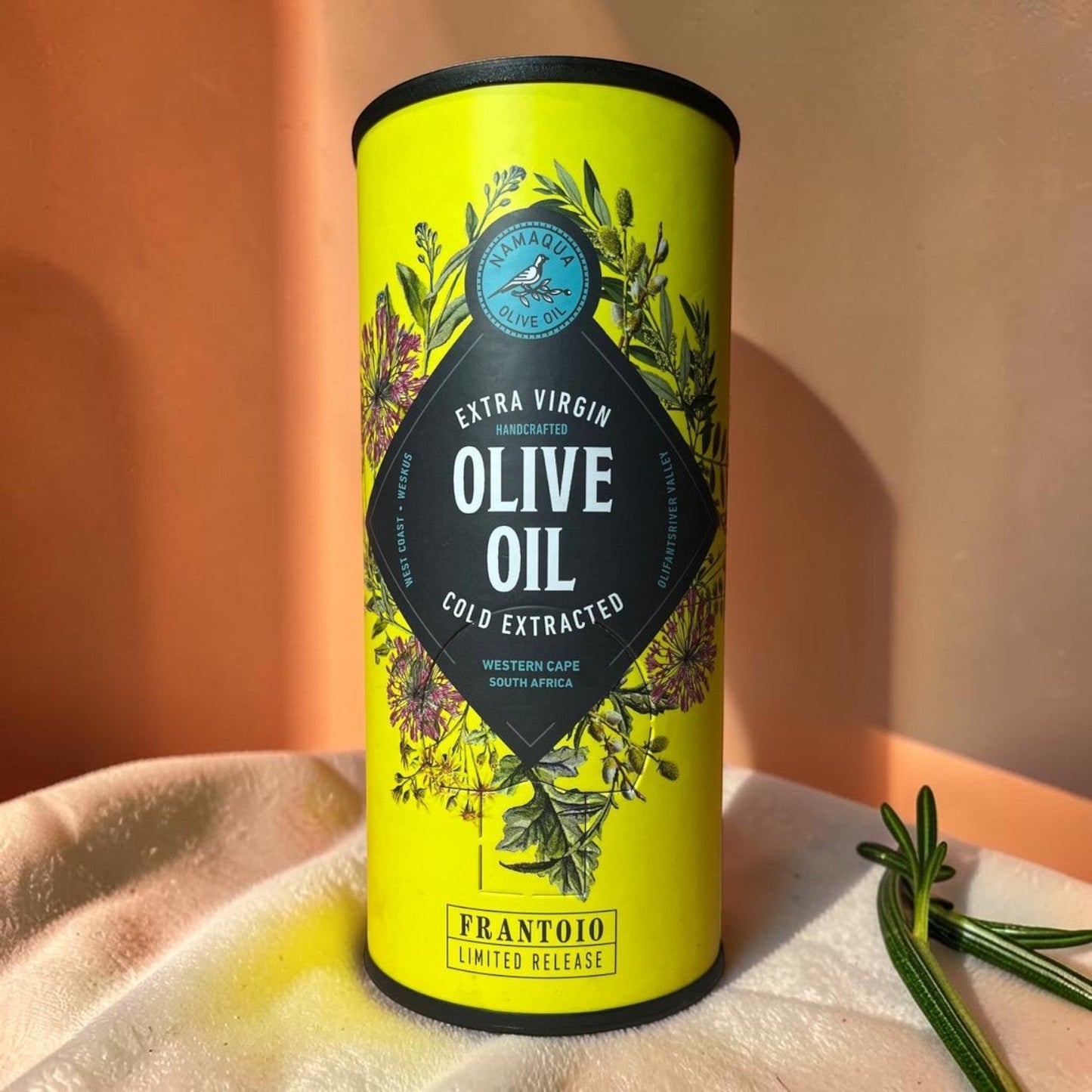 Die Spens Clarens Namaqua Frantoio Limited Release Extra Virgin Olive Oil in a bright yellow tin with botanical illustrations.