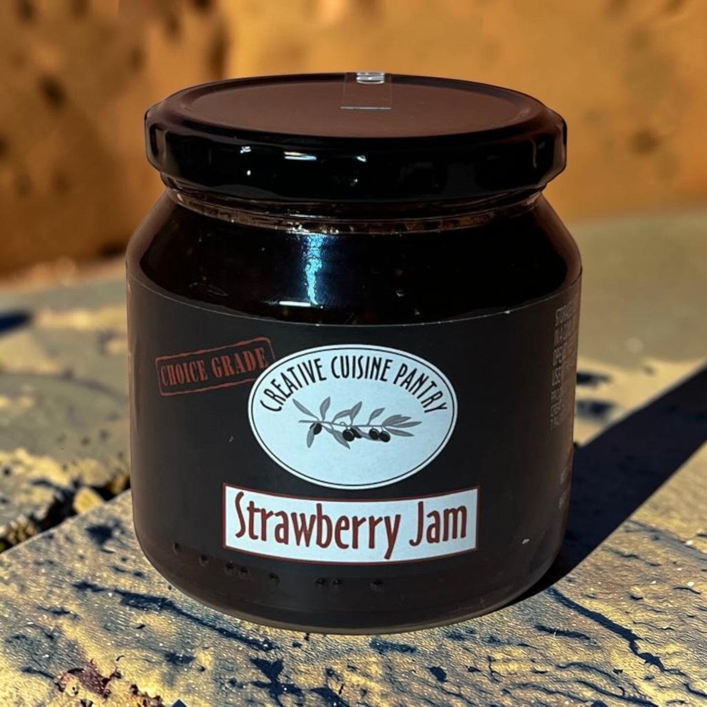 Die Spens Clarens Creative Cuisine Strawberry Jam in a glass jar with a black lid. Choice grade jam.