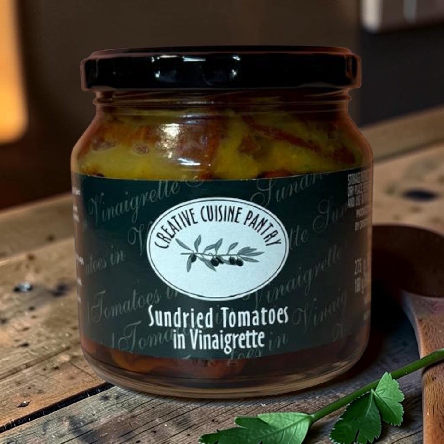 Die Spens Clarens Creative Cuisine Sundried Tomatoes in Vinaigrette jar with dark lid and label featuring olives.