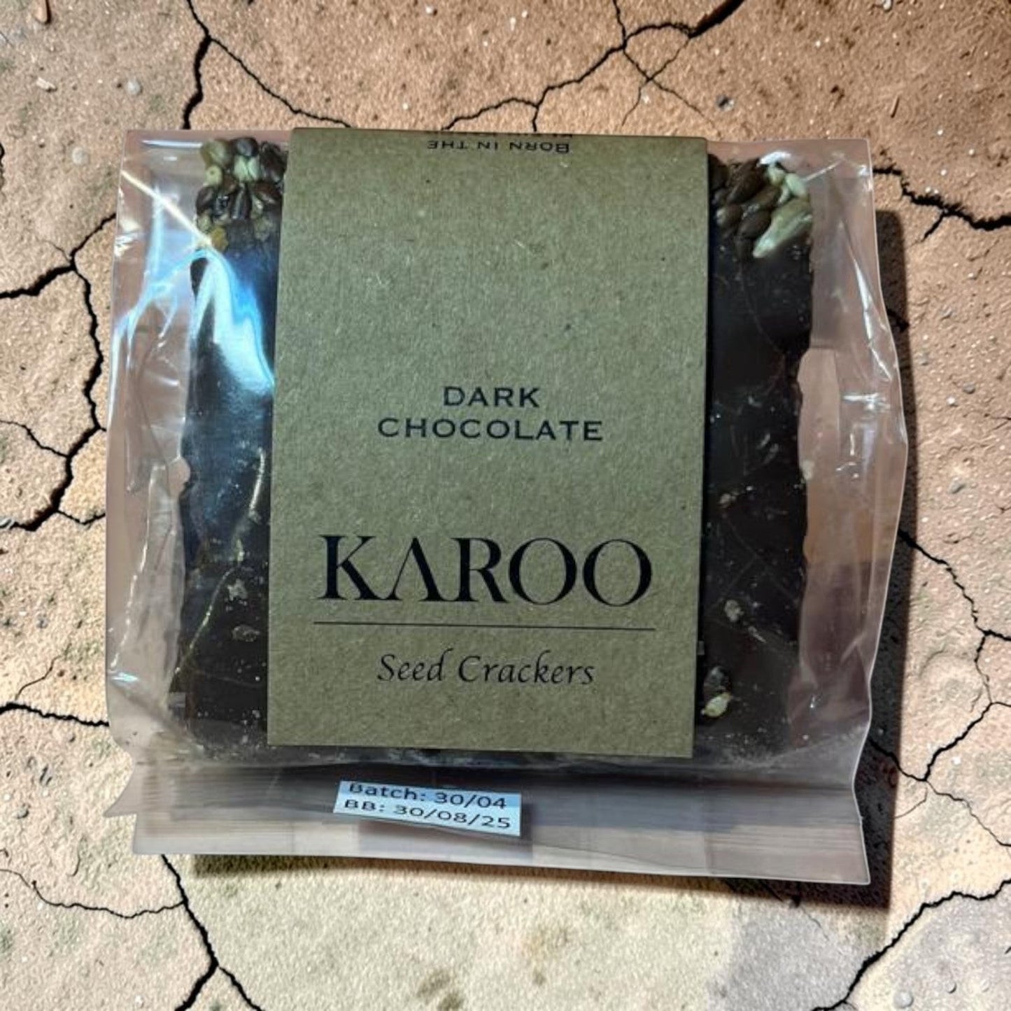 Die Spens Clarens Dark Chocolate Seed Crackers, a rich, crunchy snack with visible seeds and dark chocolate pieces.