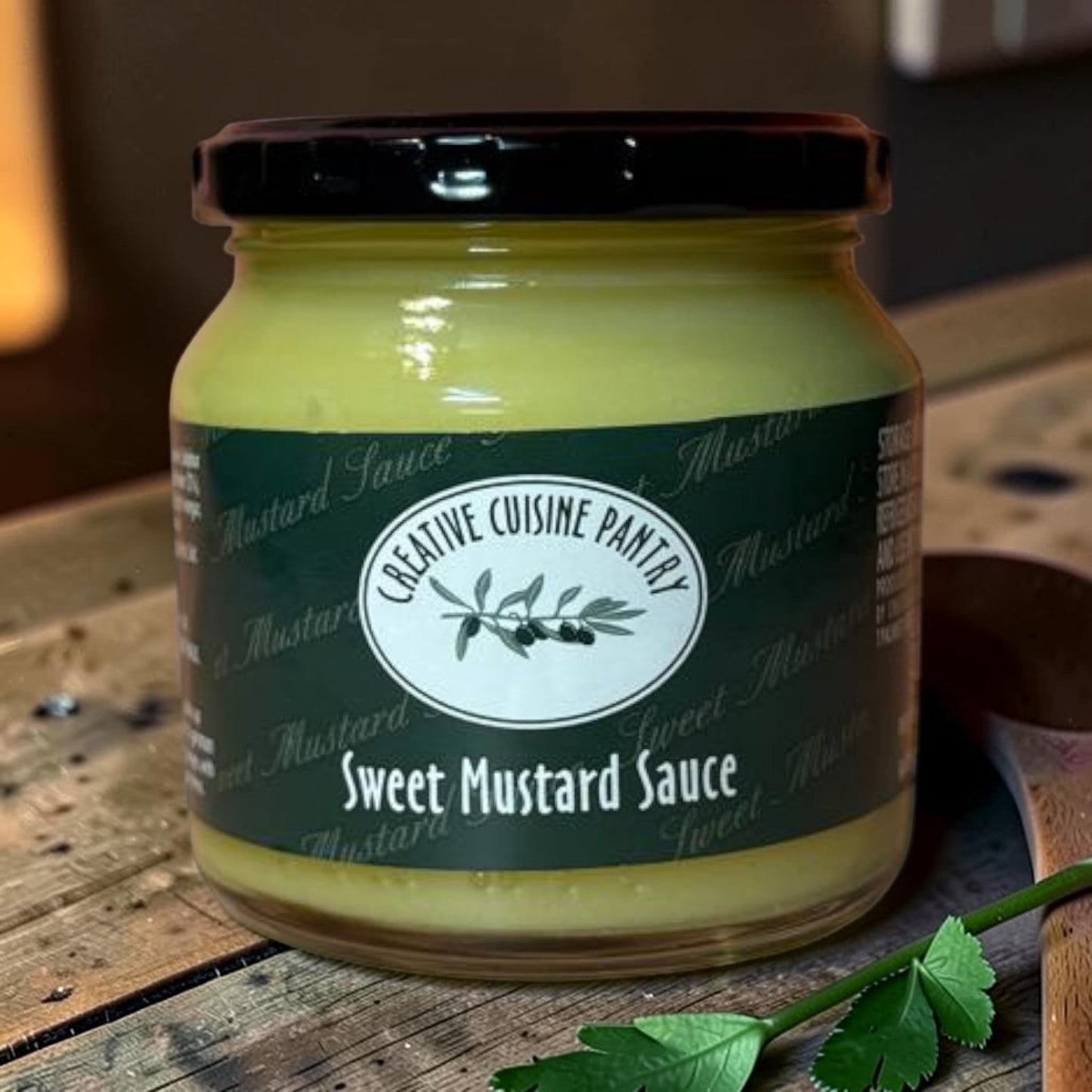 Die Spens Clarens Sweet Mustard Sauce in a glass jar with a black lid, featuring a dark green label with white text and olive branch logo.
