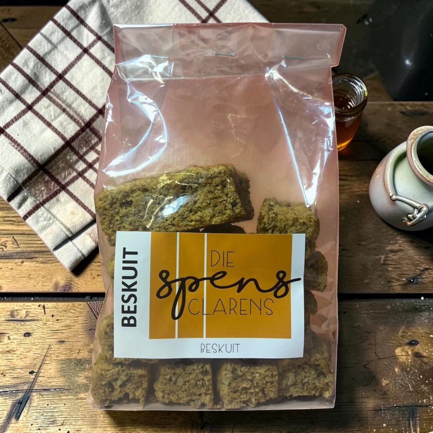 Die Spens Clarens All Bran Beskuit biscuits in a clear plastic bag, showing their textured, golden-brown appearance.