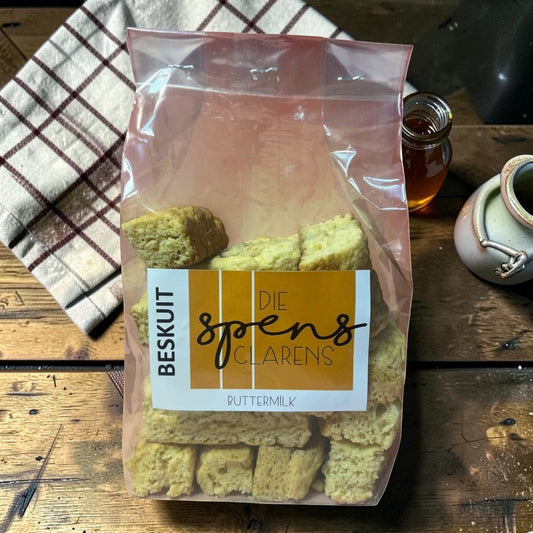 Die Spens Clarens Buttermilk Rusks in a clear plastic bag, showing golden-brown, crunchy biscuits perfect for dipping.