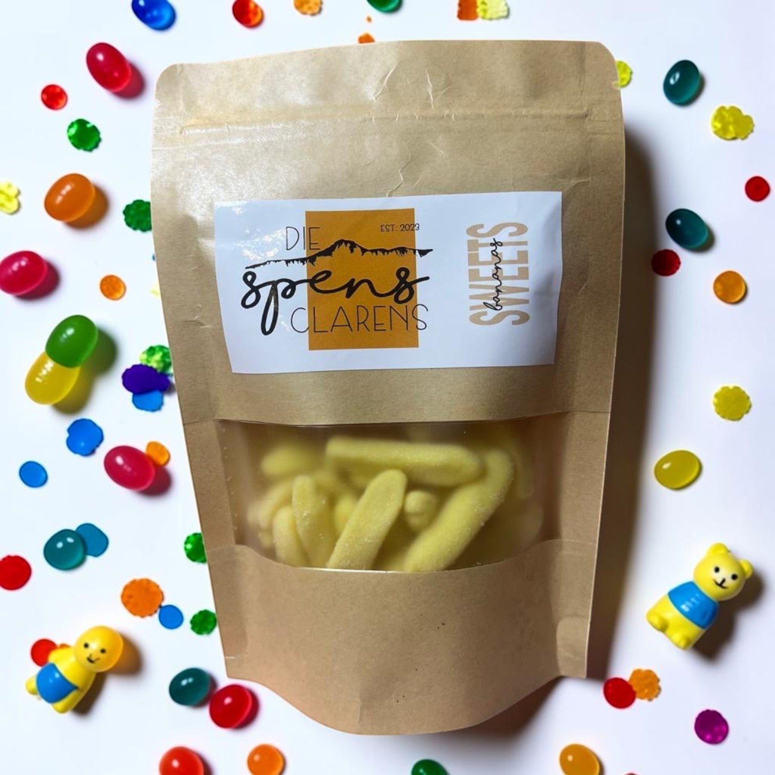 Die Spens Clarens yellow banana gummy candies in a resealable bag, coated in sugar.