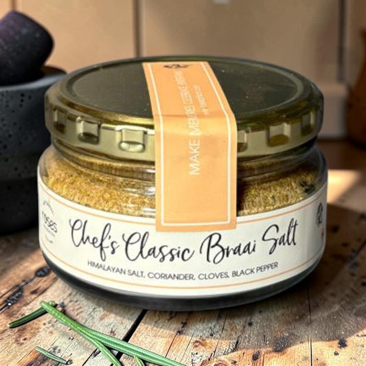 Die Spens Clarens Chef's Classic Braai Salt in a glass jar with a gold lid. Blend of Himalayan salt, coriander, cloves, and black pepper.