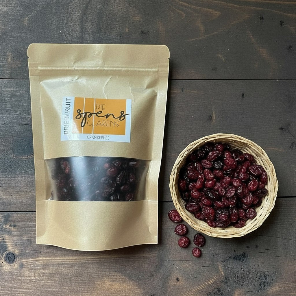 Die Spens Clarens dried cranberries in a resealable bag and a small woven basket, showcasing their deep red color and chewy texture.