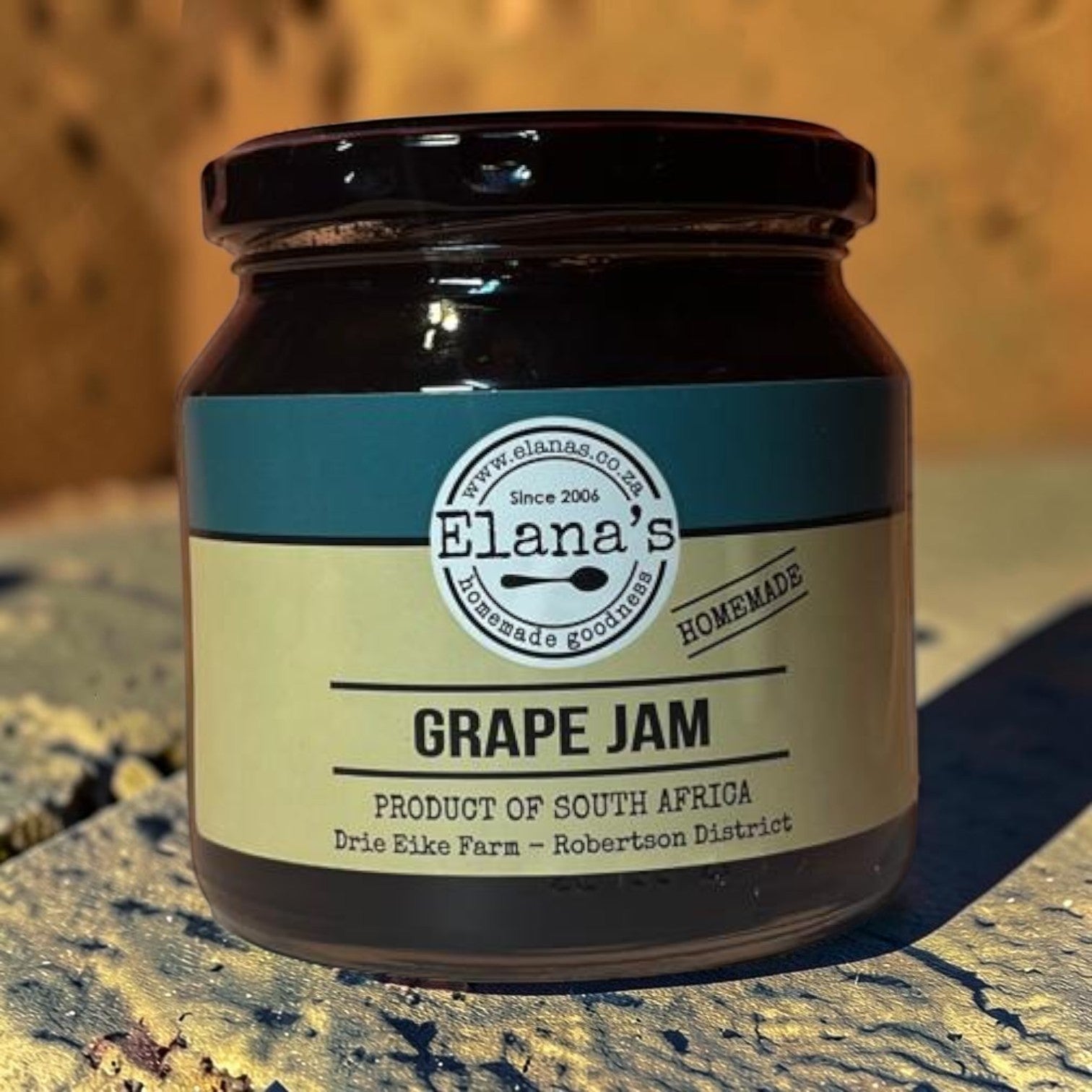Die Spens Clarens Elana's Grape Jam in a glass jar with a black lid. The label is cream and teal with 'Grape Jam' prominently displayed.