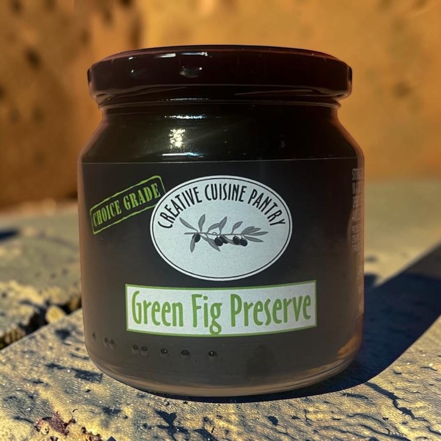 Die Spens Clarens Green Fig Preserve in a glass jar with a dark lid. Features a label with 'Choice Grade' and 'Creative Cuisine Pantry' logo.