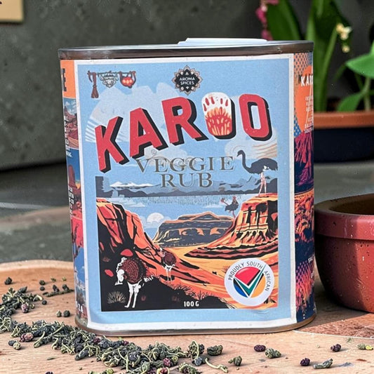 Die Spens Clarens Aroma Spices Karoo Veggie Rub tin featuring a South African landscape with ostriches and mountains. 100g.