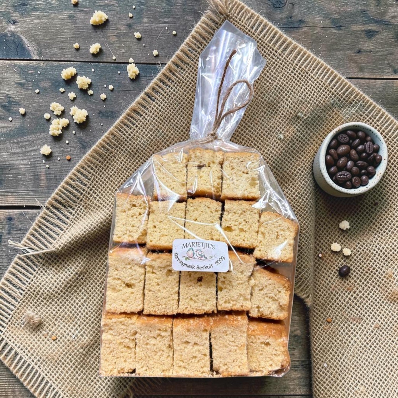 Die Spens Clarens Marietjies Karringmelk Beskuit, golden-brown baked rusks in a clear plastic bag, perfect for dipping.