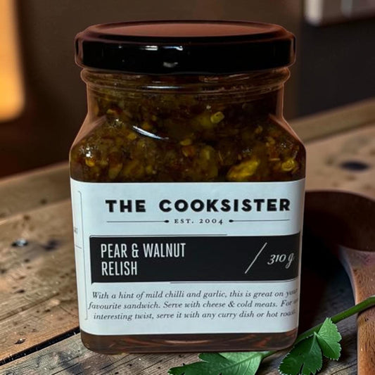 Die Spens Clarens Pear & Walnut Relish in a glass jar with a black lid. The relish contains visible pieces of pear and walnut.