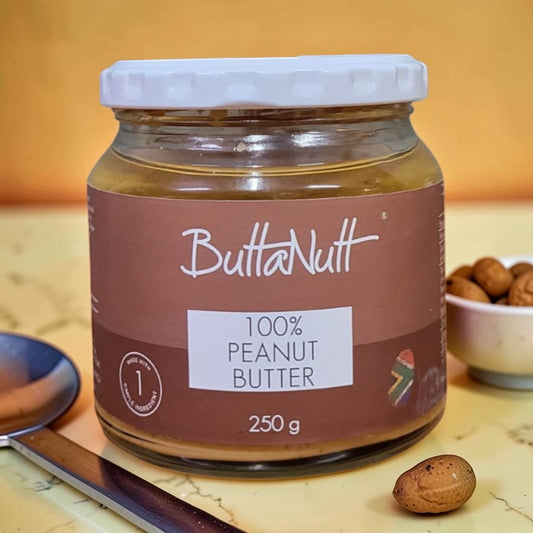 Die Spens Clarens Buttanutt 100% Peanut Butter in a glass jar with a white lid. Creamy peanut butter spread.