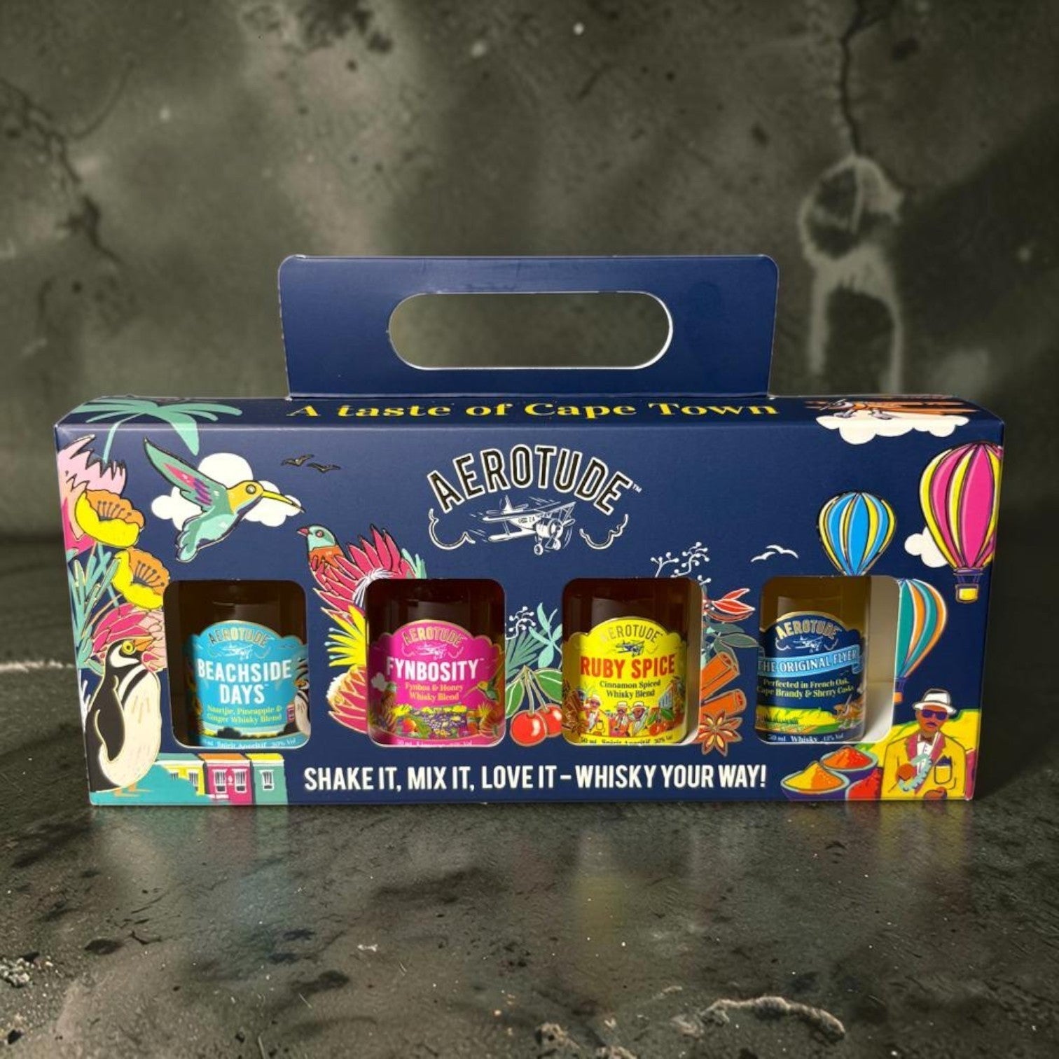 Die Spens Clarens Aerotude Mini Gift Box with four whisky variants: Beachside Days, Fynbosity, Ruby Spice, and The Original. Features vibrant illustrations of birds, penguins, and hot air balloons.