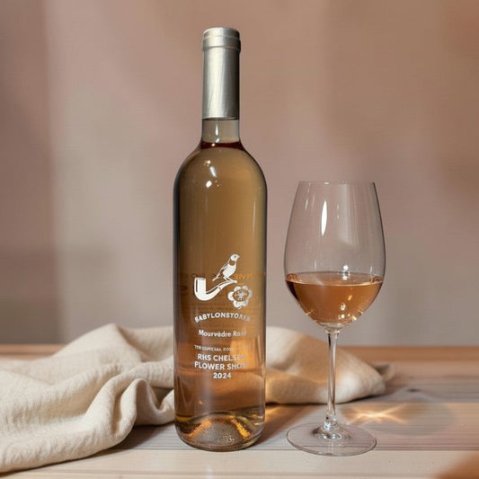 Die Spens Clarens Babylonstoren Mourvèdre Rosé wine bottle and glass with pale pink rosé wine.