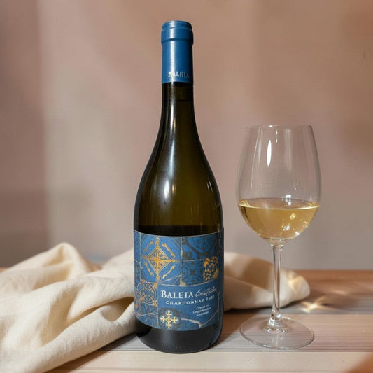 Die Spens Clarens Baleia Chardonnay Limitados 2022 white wine bottle and glass with pale gold hue.