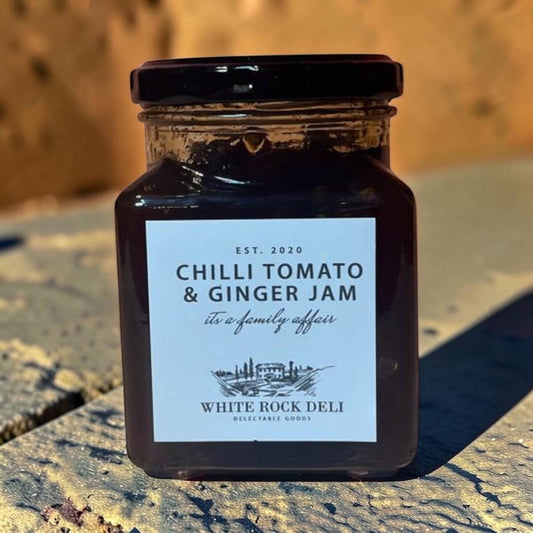 Die Spens Clarens Chilli Tomato & Ginger Jam in a glass jar with a black lid. The label is white with black text and a scenic illustration.