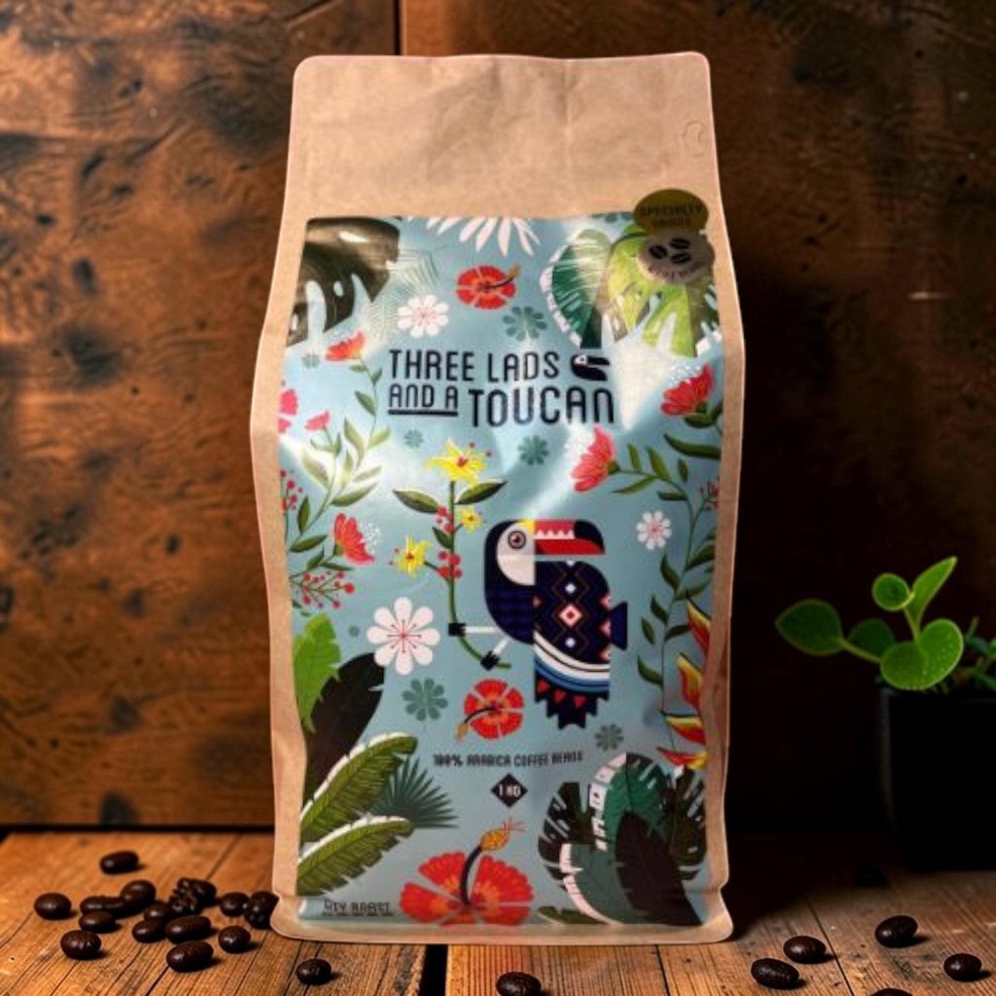 Die Spens Clarens Three Lads and a Toucan City Roast 100% Arabica coffee beans in a colourful bag with a toucan design.