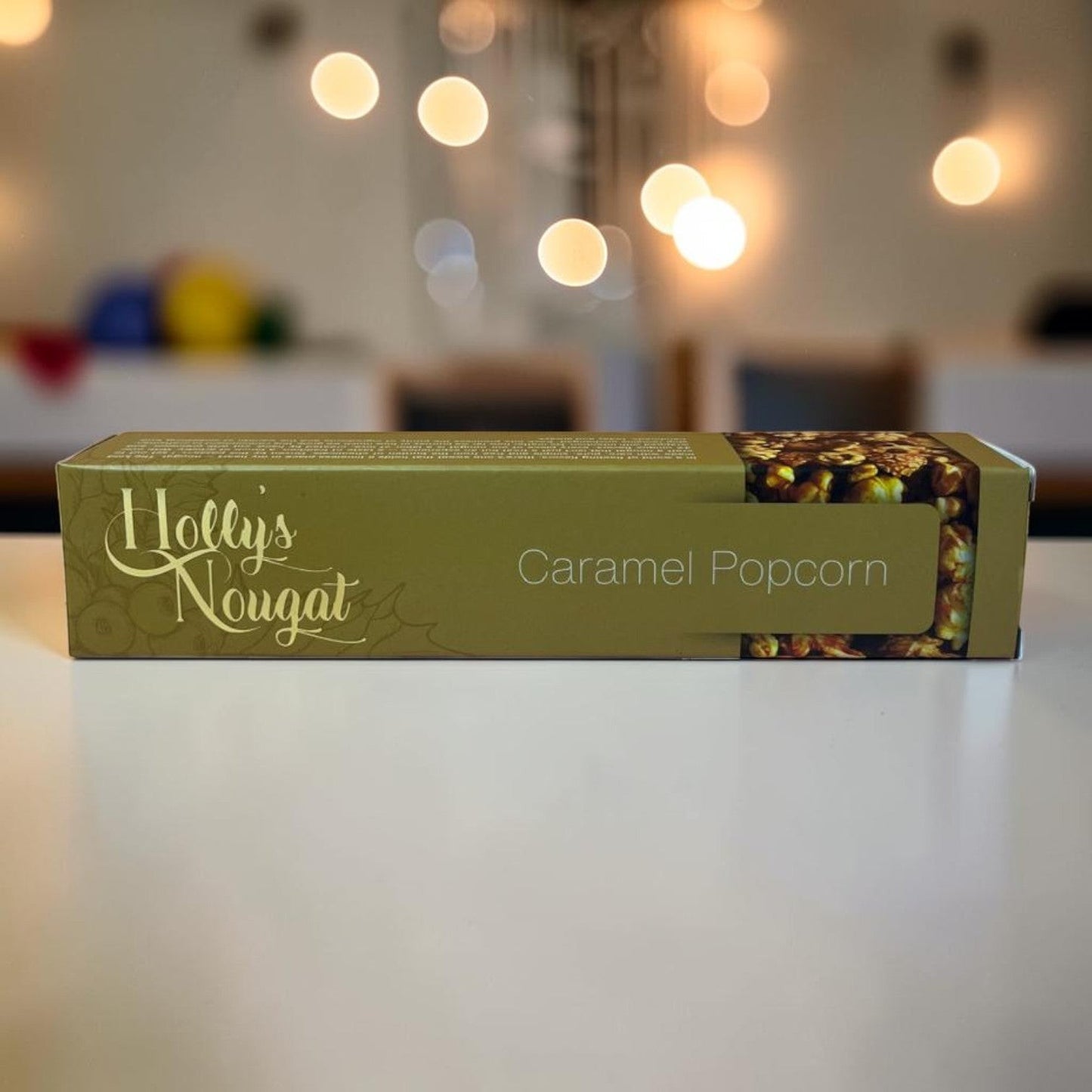 Die Spens Clarens Holly's Nougat Caramel Popcorn box, featuring a window showing crunchy caramel popcorn.