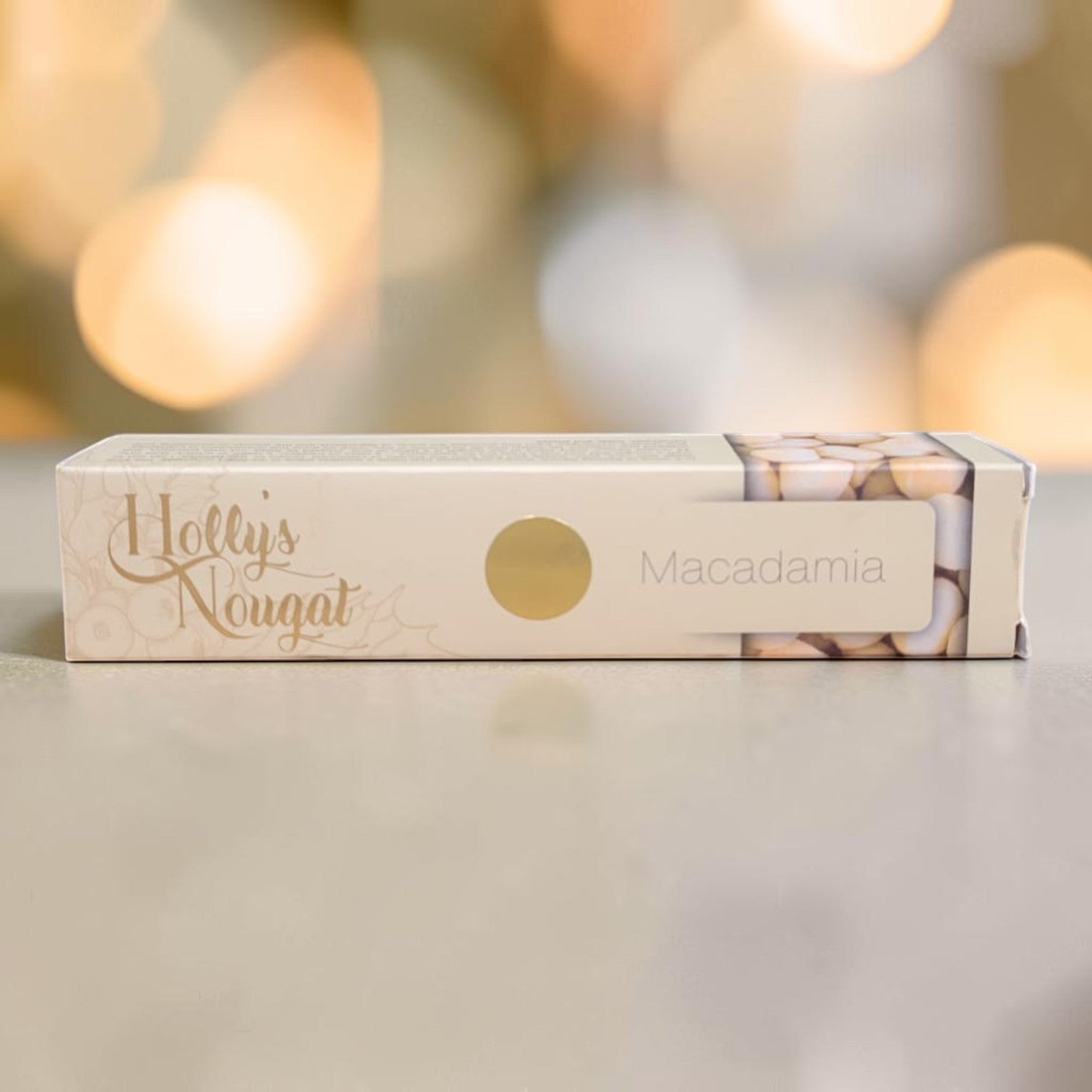 Die Spens Clarens Holly's Nougat Macadamia bar with visible macadamia nuts through packaging window.
