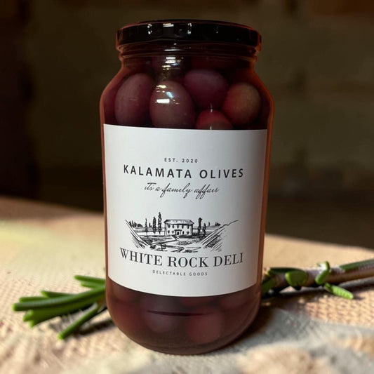 Die Spens Clarens White Rock Deli Kalamata Olives in a glass jar, deep purple, brined for authentic Greek flavor.