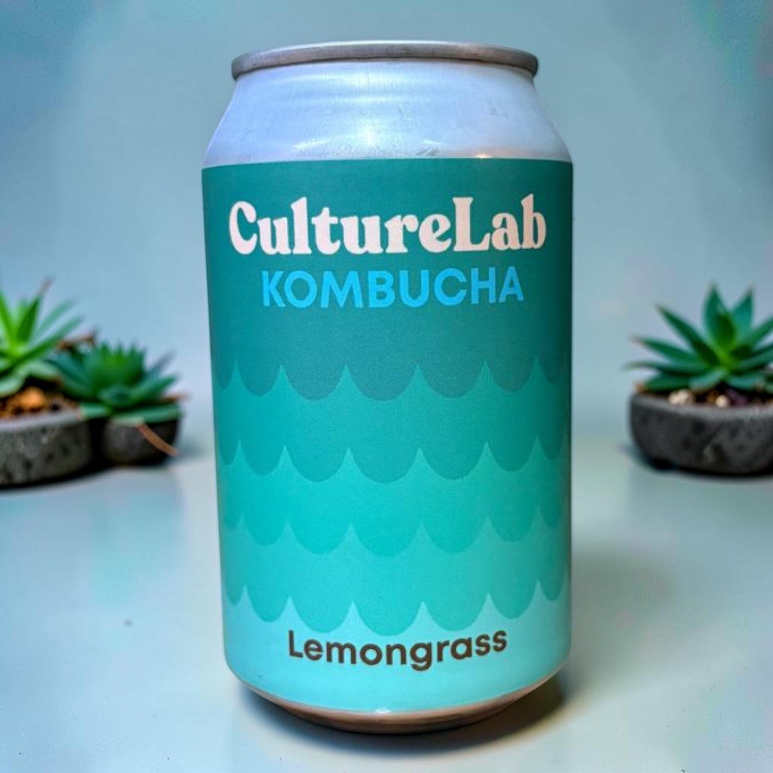 Die Spens Clarens Culture Lab Lemongrass Kombucha can with teal wave design, refreshing and healthy beverage.