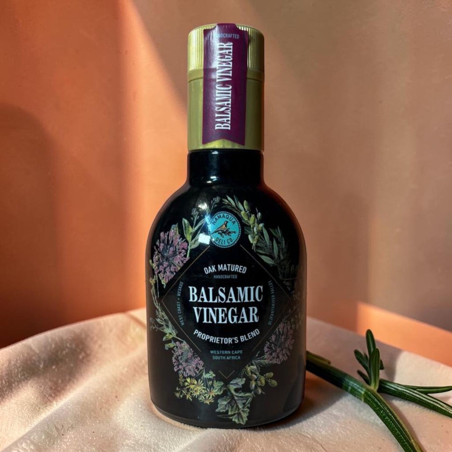 Die Spens Clarens Namaqua oak-matured balsamic vinegar in a dark glass bottle with floral detailing.