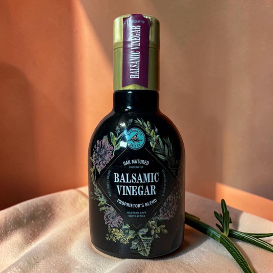 Die Spens Clarens Namaqua oak-matured balsamic vinegar in a dark glass bottle with floral detailing.