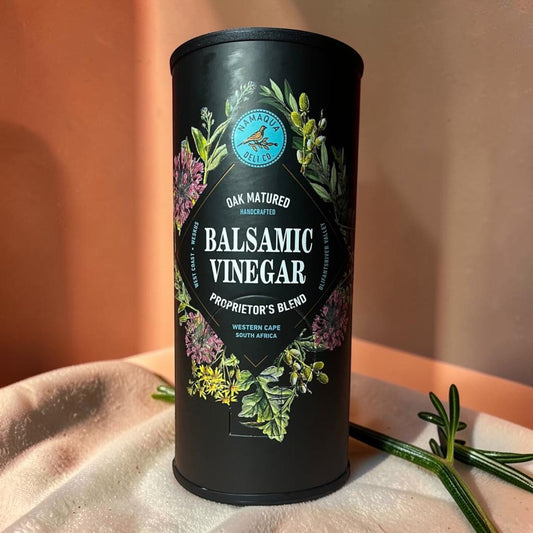 Die Spens Clarens Namaqua oak-matured balsamic vinegar proprietor's blend in a black tin with botanical illustrations.