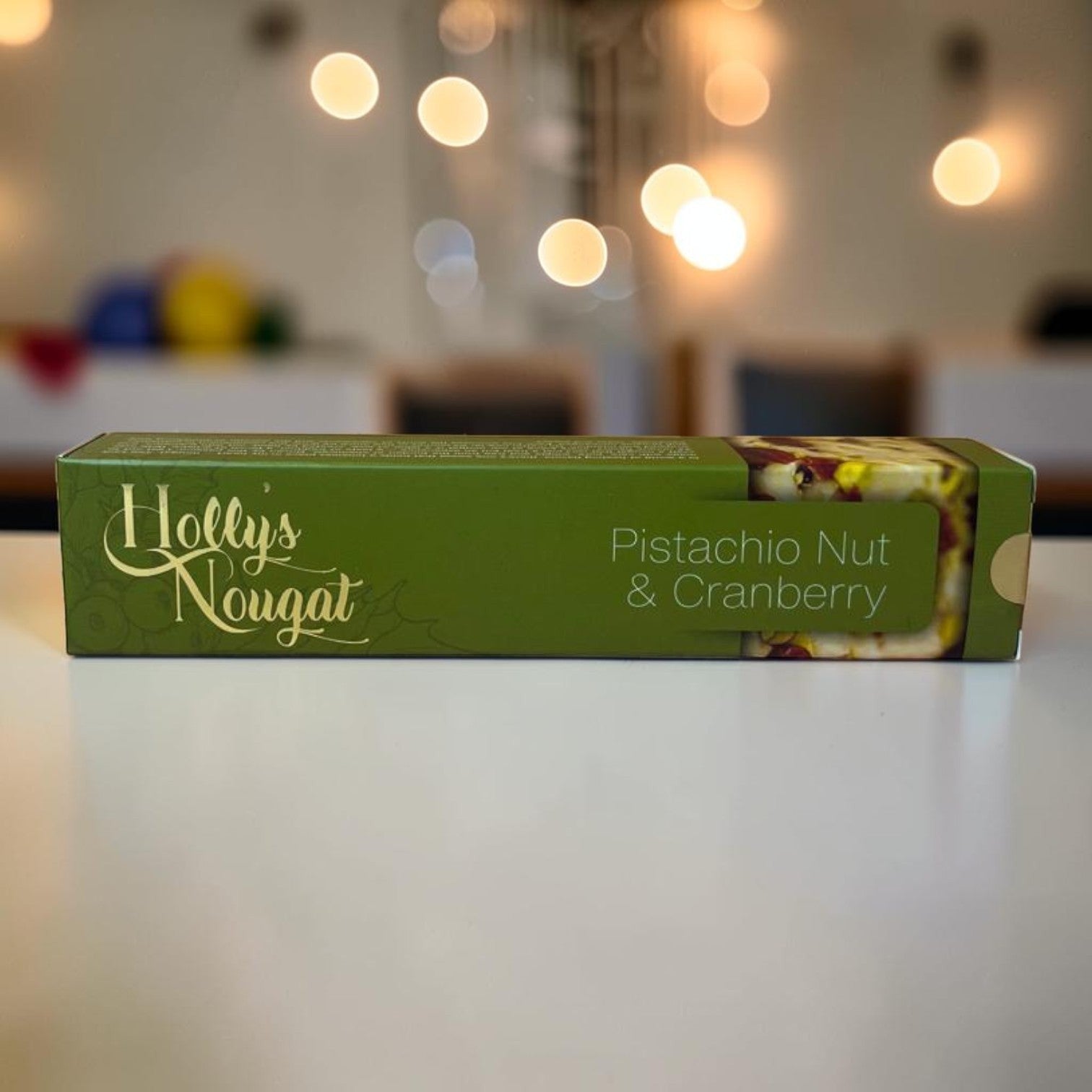 Die Spens Clarens Holly's Nougat Pistachio Nut & Cranberry bar with visible nuts and dried berries.