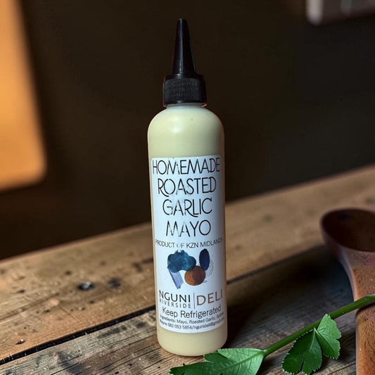 Die Spens Clarens Nguni Deli homemade roasted garlic mayo in a squeeze bottle with a black cap.