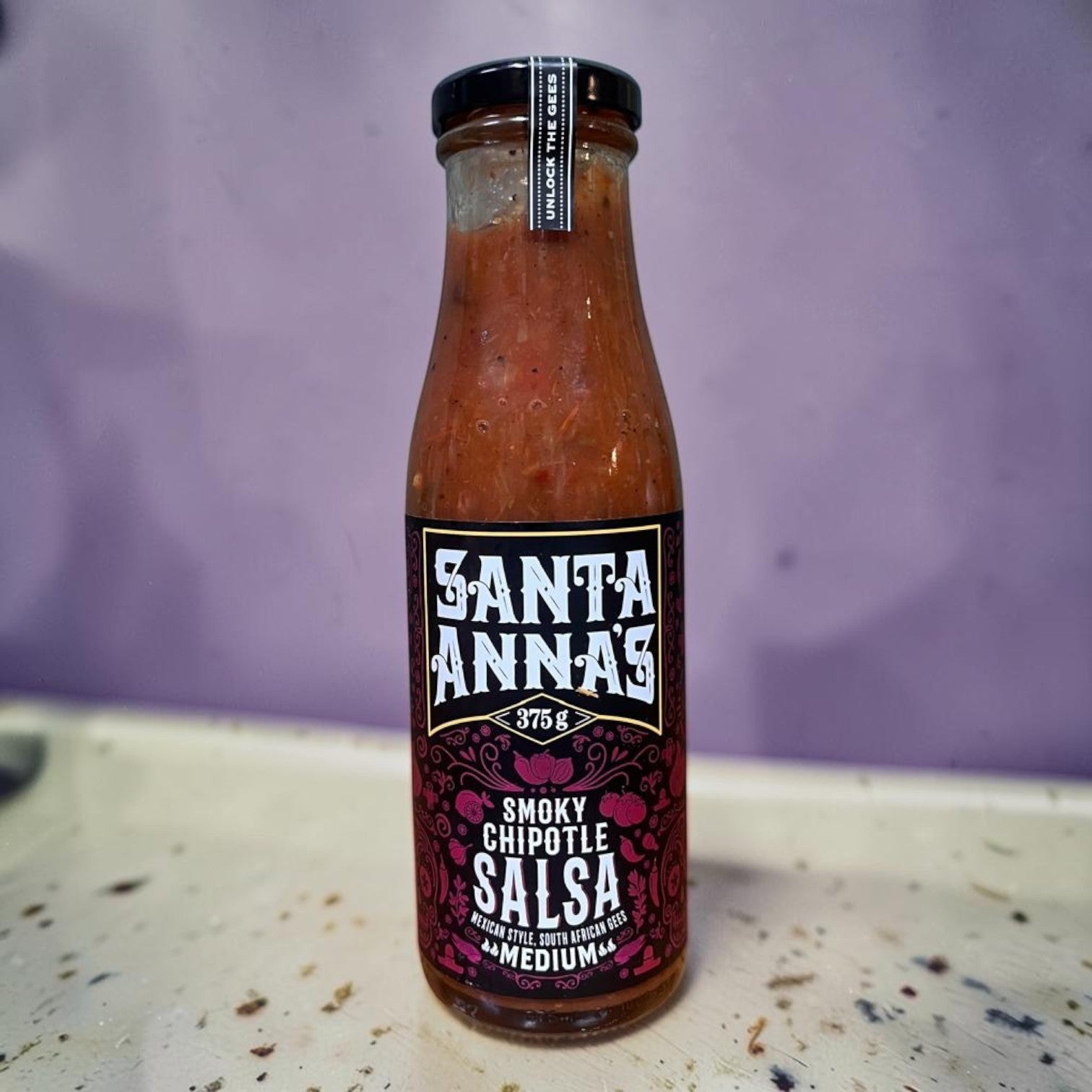 Die Spens Clarens Santa Annas Smoked Chipotle Salsa in a glass bottle, medium heat, Mexican style with South African flair.