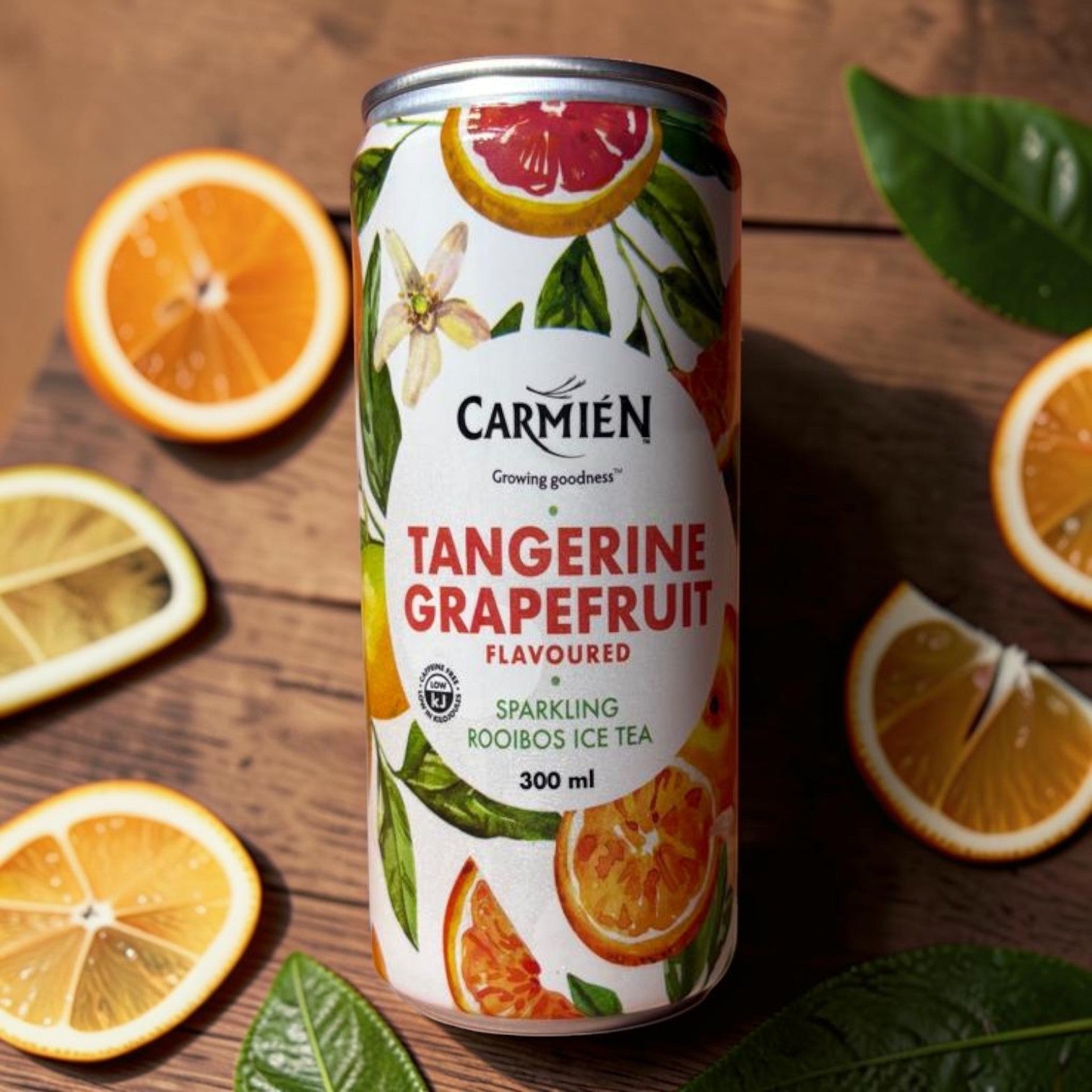 Die Spens Clarens Carmien Tangerine Grapefruit sparkling rooibos ice tea can with citrus slices and leaves.