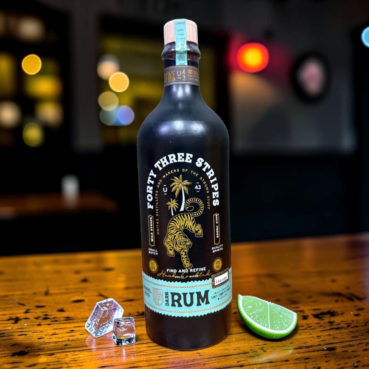 Die Spens Clarens Unit 43 Stripes Rum bottle with tiger and palm tree label, served with ice and lime.