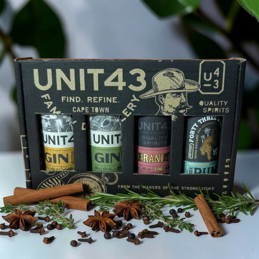 Die Spens Clarens Unit 43 Mixed Mini Box featuring 4 spirit bottles: Original Gin, Oak Wooded Gin, Brandy, and Rum, presented in a custom gift box with spices.