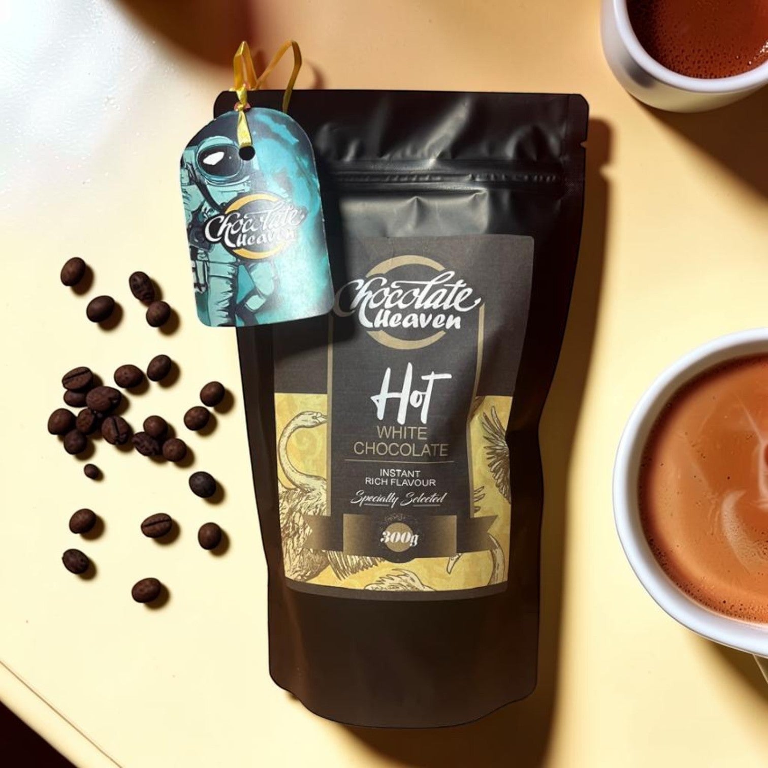Die Spens Clarens Chocolate Heaven instant white hot chocolate pouch with coffee beans and two cups of hot chocolate.