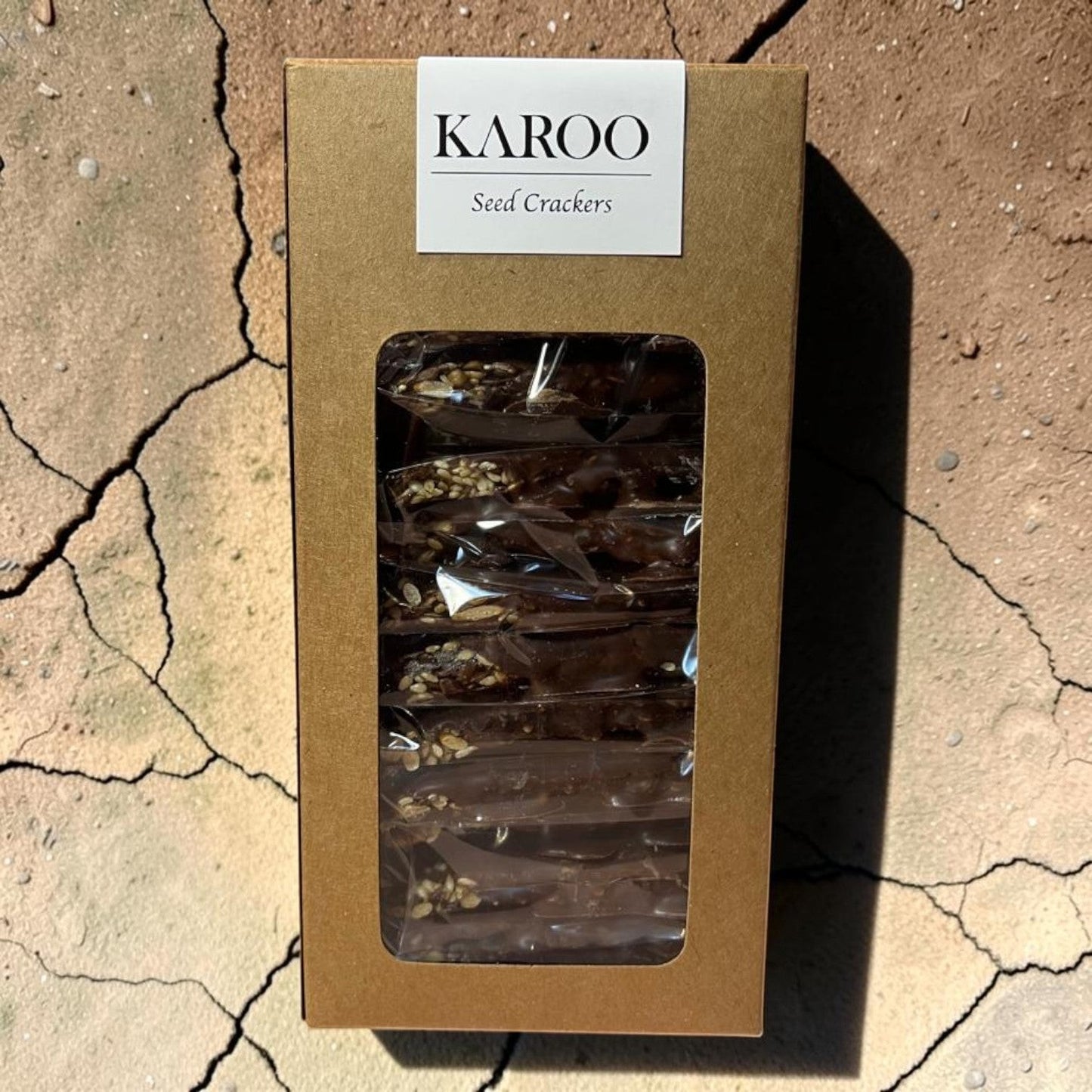 Die Spens Clarens Karoo Dark Chocolate Seed Crackers, a box of individually wrapped seed crackers coated in dark chocolate.