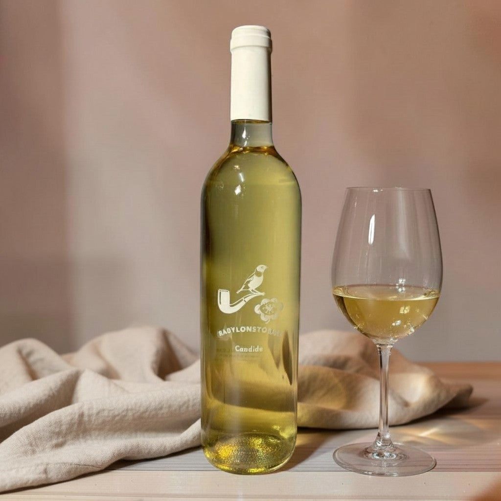 Die Spens Clarens Babylonstoren Candide white wine bottle and glass, pale straw hue, citrus and floral notes.