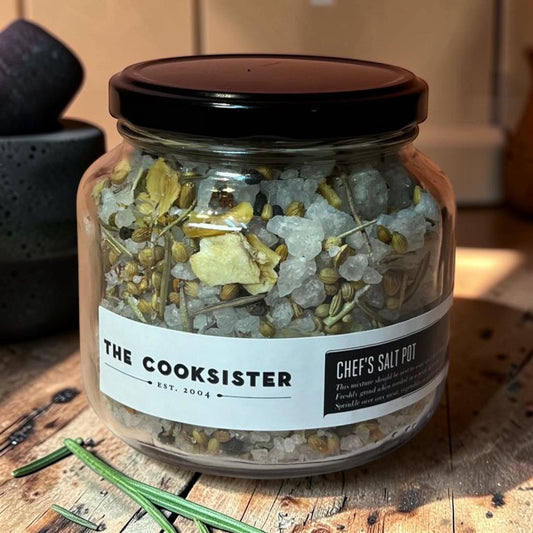 Die Spens Clarens Cooksister Chef's Salt Pot in glass jar with black lid, featuring coarse sea salt with herbs and spices.