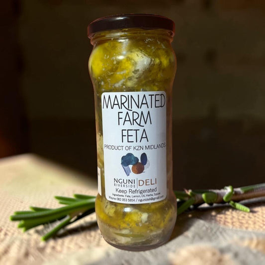 Die Spens Clarens Nguni Deli marinated farm feta cheese in a glass jar with herbs and spices.