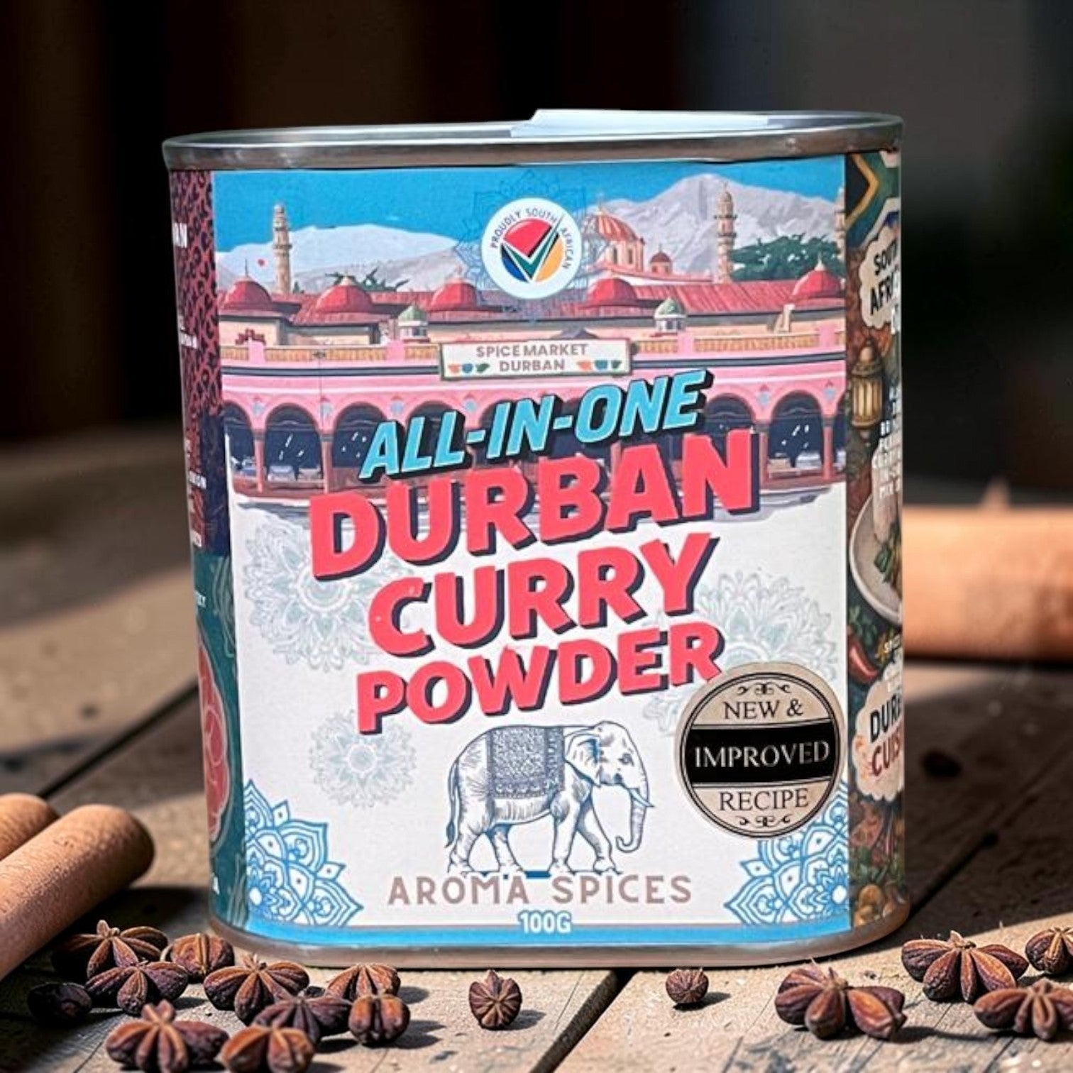 Die Spens Clarens Aroma Spices All-in-One Durban Curry Powder tin featuring an elephant and South African landmarks. Improved recipe.