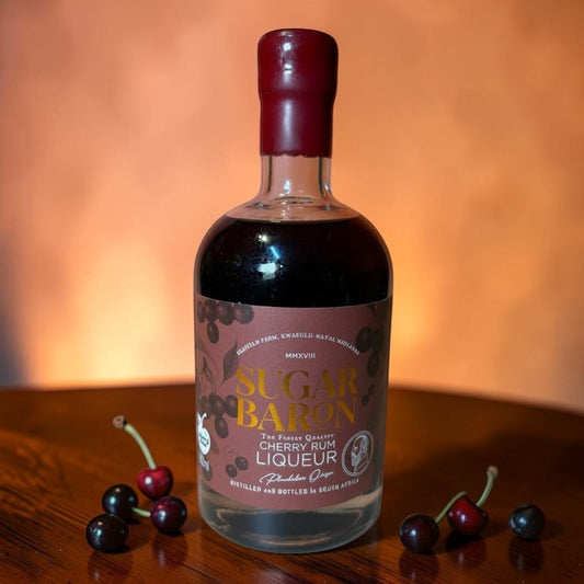 Die Spens Clarens Sugar Baron Cherry Rum Liqueur, a deep ruby coloured liqueur with a maroon wax seal and label featuring cherries.